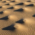 Smooth mounds contrast with the rippled sand, highlighting natural wind Royalty Free Stock Photo