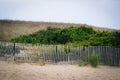 Sand dunes and fence in Sandwich, Cape Cod, Massachusetts. Royalty Free Stock Photo