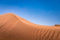 Sand dunes in the golden desert of Al Wasil, central Oman.