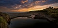 Sand Dunes with grasses and reflective rockpool, with dark stormy sky`s Royalty Free Stock Photo