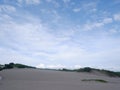 Sand Dunes hill white beach Green grass, and bright blue sky Royalty Free Stock Photo