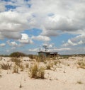 Sand dunes and a house in the foreground Royalty Free Stock Photo