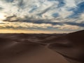 Sand dunes in Morocco, desert landscape, sand texture, tourist camp for night stay, panorama view of sunset over Sahara