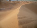 Sand dunes in Morocco, desert landscape, sand texture, tourist camp for night stay, panorama view of sunset over Sahara Royalty Free Stock Photo