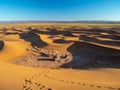 Sand dunes in Morocco, desert landscape, sand texture, tourist camp for night stay, panorama view of sunset over Sahara Royalty Free Stock Photo