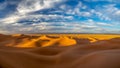Sand dunes in Morocco, desert landscape, sand texture, tourist camp for night stay, panorama view of sunset over Sahara Royalty Free Stock Photo