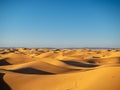 Sand dunes in Morocco, desert landscape, sand texture, tourist camp for night stay, panorama view of sunset over Sahara Royalty Free Stock Photo