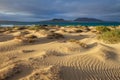 Sand dunes and ocean on sunset Royalty Free Stock Photo