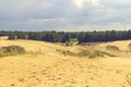 Sand dunes and pines, the sky in the clouds. Car in the background Royalty Free Stock Photo