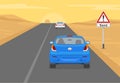 Sand dunes road or traffic sign. Blue car goes up the desert hill on highway. Royalty Free Stock Photo