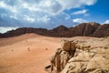 Sand dunes with truck tracks and mountain backdrop, Wadi Rum Reserve, Jordan Desert Royalty Free Stock Photo