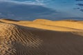 Sand dunes of the Sahara desert lit by the light of the setting sun of the sun Royalty Free Stock Photo