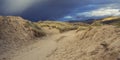 Sand dunes and stormy skies
