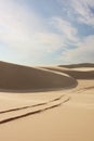 Sand dunes with tyre tracks Royalty Free Stock Photo