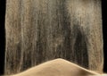 Sand fall down on hill like a rain and splash fly in air. Sand dune hill over wind storm and blast dust splash over mountain. Royalty Free Stock Photo