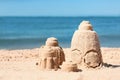 Sand figures on beach near sea Royalty Free Stock Photo