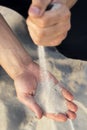 Sand flowing through your fingers. Hand with the sand Royalty Free Stock Photo