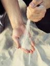 Sand flowing through your fingers. Hand with the sand Royalty Free Stock Photo