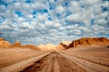 Sand formations, mountains, rocks at Valle de la Luna Moon Valley, San Pedro de Atacama Chile. Wide view of stunning sun rise on Royalty Free Stock Photo