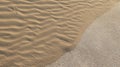 Sand invading the pavement with wind marks on the Cantabrian beach