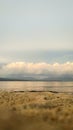 Sand Lakeside in the Afternoon with Calm Lake under the Clouds