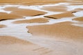 Sand landscape at low tide with water grooves