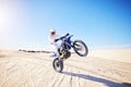 Sand, motorbike balance and sports person doing trick, skill or stunt on off road challenge, training and freestyle