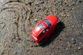 On the sand near the coastal line is a red car from him left traces of his movement Royalty Free Stock Photo