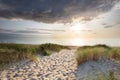 Sand path to north sea beach at sunset Royalty Free Stock Photo