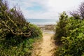 Sand pathway access french sea coast with sunny atlantic beach sea in summer day Royalty Free Stock Photo