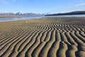 Sand patterns at the beach at low tide on a sunny day Royalty Free Stock Photo