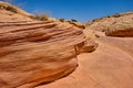 Sand, pebbles and smooth colorful rocks carved from aztec sandstone create a gully in the Nevada Desert