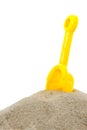 Sand pile with yellow toy shovel