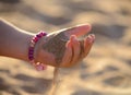 Sand pours out of the child hand