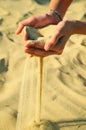 Sand pours out of the female hands Royalty Free Stock Photo