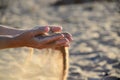 Sand pours out of the hands