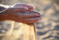 Sand pours out of the hands Royalty Free Stock Photo