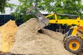 sand pours out of a tractor bucket Royalty Free Stock Photo