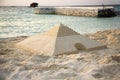 Sand pyramid on the beach Royalty Free Stock Photo