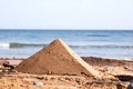 Sand pyramid on beach Royalty Free Stock Photo