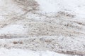 Snow-covered road with traces of sand, reagents and car tires Royalty Free Stock Photo