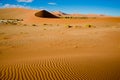 Sand riffles in desert and dunes in Namib Desert, Namibia. Orange dunes in Sossusvlei, Namibia Royalty Free Stock Photo