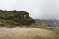 A sand road curve with traffic signals and a high paramo ecosystem peak Royalty Free Stock Photo