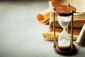 Sand running through the hourglass and old vintage books. Time keeper concept. Royalty Free Stock Photo
