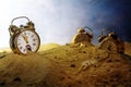 Sand running out of an alarm clock, other watches sink into the Royalty Free Stock Photo