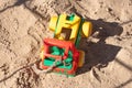 Sand in the sandbox. Childrens toy, yellow broken truck on the sand