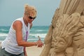 Sand sculptor working on beach