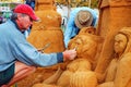 A sand sculptor working on his creation Royalty Free Stock Photo