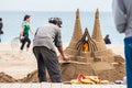 Sand sculptor working at La Barceloneta Beach in Barcelona Spain