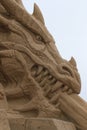 Sand sculpture - chained dragon. Head, right view. Close-up